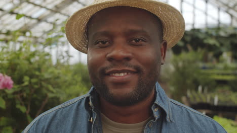 Portrait-of-Cheerful-African-American-Male-Farmer-in-Greenhouse